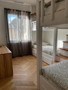 a bedroom with two bunk beds and a window at Villa Lavande in Sainte-Maxime