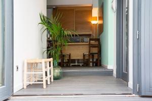 a porch with a chair and a table with a plant at Villa Miel in Cala Millor