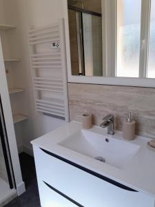a bathroom with a white sink and a mirror at Villa Lavande in Sainte-Maxime +34 photos