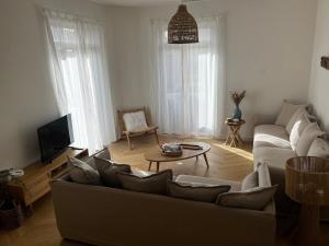 a living room with a couch and a table at Villa Lavande in Sainte-Maxime