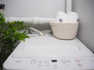 a basket of toilet paper sitting on top of a washing machine at 2 巣鴨駅5分 5人房 1LDK 便利热闹丨Sugamo JR Line 5 minutes 5people in Tokyo +27 photos