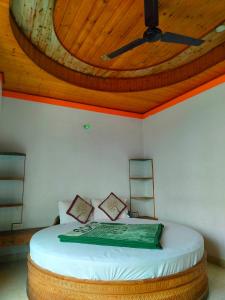 a bedroom with a bed with a wooden ceiling at Hotel Kingsway Near Mall Road in Shimla
