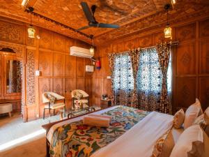 a bedroom with a bed and wooden walls at Moustache Houseboat Srinagar in Srinagar