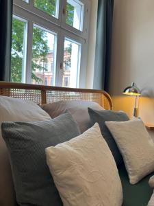 a bedroom with a bed with pillows and a window at Ferienapartment Janow in Spantekow +17 photos