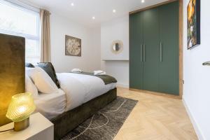 a bedroom with a bed and a green door at A spacious and modern 4Bedroom house in Borehamwood