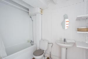 a white bathroom with a toilet and a sink at Oliwood Beach - Gran Hotel in Playa Oliva Nova +36 photos