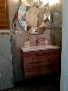 a bathroom with a sink and a mirror at Prie mariu in Nida