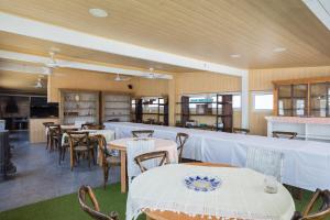 a restaurant with tables and chairs with white table cloth at Oliwood Beach - Gran Hotel in Playa Oliva Nova