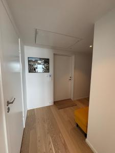 an empty room with a white door and a bed at Wonderful apartment in centrum in Tromsø +12 photos