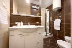 a bathroom with a sink and a toilet at Sun Spalato Maslinica in Maslinica +22 photos