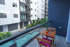 a balcony with a table and two chairs and a pool at Blue Palm Pool, quiet and comfort in Tangier in Tangier