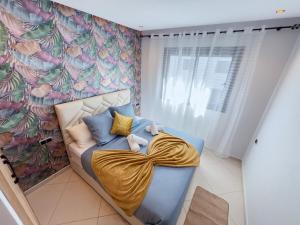 a room with a blue couch with a flower wall at Blue Palm Pool, quiet and comfort in Tangier in Tangier +17 photos