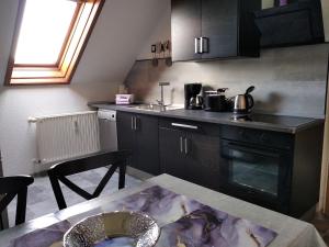a kitchen with a table and a counter top at Monteurwohnung Lugau in Lugau