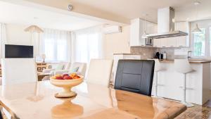 a kitchen with a bowl of fruit on a table at VILLA Rübezahl in Benidorm