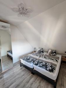 une chambre avec deux lits et un ventilateur de plafond dans l'établissement Ferienwohnung Richter, à Pirna