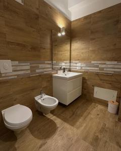 a bathroom with a toilet and a sink at B&B Dalmazia Trani in Trani