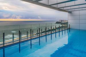 a swimming pool with a view of the ocean at Le Collective Sokcho Beach in Sokcho