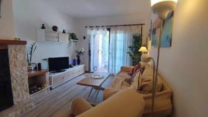 a living room with a couch and a fireplace at Casa Blanca 42 – Piscina, BBQ y Wifi (5 pax) in Tossa de Mar
