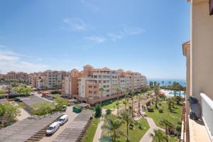 a view of a resort with palm trees and the ocean at Apartamento en Isla Canela in Ayamonte