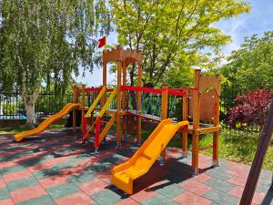 a playground with a slide in a park at Daisy Studios Harmony Hills in Rogachevo
