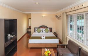 Postel nebo postele na pokoji v ubytování The Cardamom Thekkady