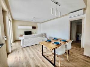 a living room with a wooden table and chairs at Casa Bramardi in San Defedente di Cervasca