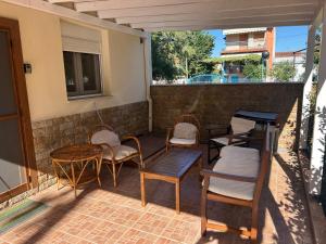 a patio with chairs and tables and a table at Kaly Mare Sithonia in Kalyves Poligirou