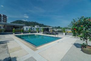 a swimming pool in the middle of a building at Di Yana Patong in Patong Beach