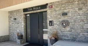a door to a building with a heart on it at Vila Mojca SKI IN&OUT - Apartmaji Lena in Kranjska Gora +66 photos