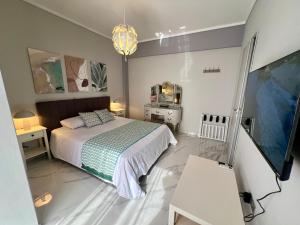 a bedroom with a bed and a television in it at Paradise City Apartment 2 in Rhodes Town