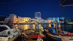 two boats are docked in a harbor at night at In The Heart Of Medina Bizerte and 5 min from the beach in Bizerte