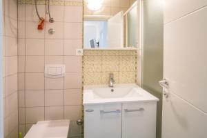 a small bathroom with a sink and a shower at Apartments Iva in Krk +106 photos