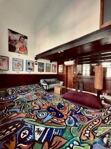 a bedroom with a large bed with a design on it at otto7senses in Haifa