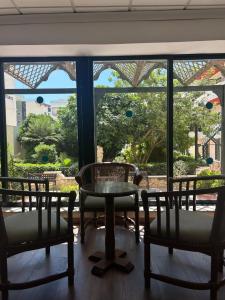 a room with two chairs and a table and a window at The San Anton Hotel in St Paul's Bay
