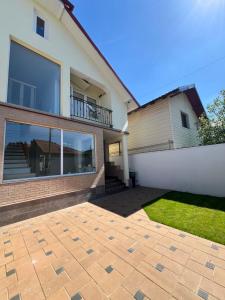 a house with a brick patio in front of it at Central Loft Studio Târgoviște in Târgovişte