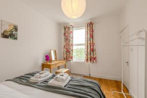 a bedroom with a bed and a window at Gorgeous 2BR plus Victorian home with Parking and Garden in London +21 photos