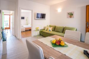 a living room with a table with fruit on it at Apartments Iva in Krk