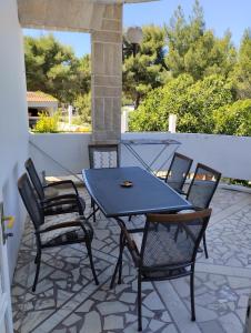 a blue table and chairs on a patio at Braco apartments by the sea with a sea view in Zaboric