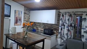 a kitchen with a table and a counter with a refrigerator at Villa Olga Rosa in Las Palmas de Gran Canaria
