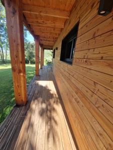 a wooden porch on a log cabin building at Chalet GOURCE avec vue sur le Château in Foix +20 photos