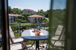 a table and chairs on a balcony with a view at Apartments Iva in Krk