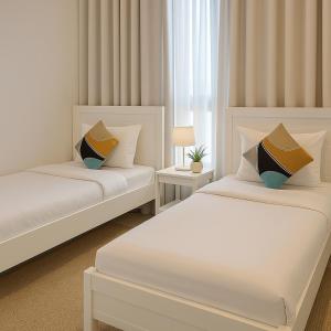 a bedroom with two beds and a window at Seascape Villa Marine in Fujairah