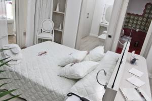 Postel nebo postele na pokoji v ubytování Boutique Hotel Paradiso Bovelacci
