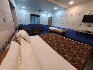 a bedroom with a large bed and a couch at Ushodaya Resorts in Araku +12 photos