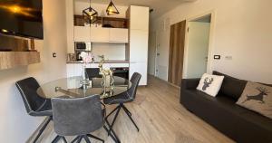 a living room with a glass table and a couch at Vila Mojca SKI IN&OUT - Apartmaji Lena in Kranjska Gora