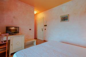Postel nebo postele na pokoji v ubytování Hotel I Ginepri