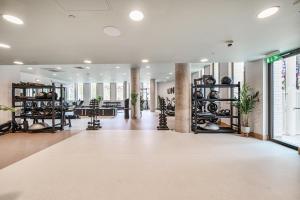 a large room with a gym with lots of equipment at Roomspace Serviced Apartments -Oasis Way in London