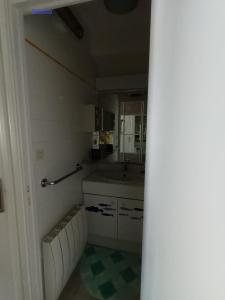 a small kitchen with a sink and a mirror at RESIDENCE LA NATURELLE Studio in Wimereux