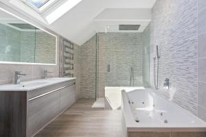 a bathroom with a tub and a sink and a shower at Shackled-Am-Not - Luxury home sleeps 8 with hot tub and games room North Cornwall in Camelford +22 photos