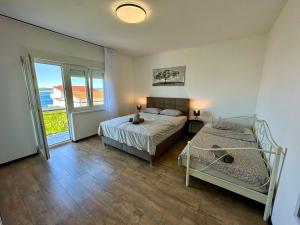Postel nebo postele na pokoji v ubytování APARTMANI KIKI